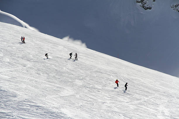 istock Skiers going down the slope at ski resort 452680713