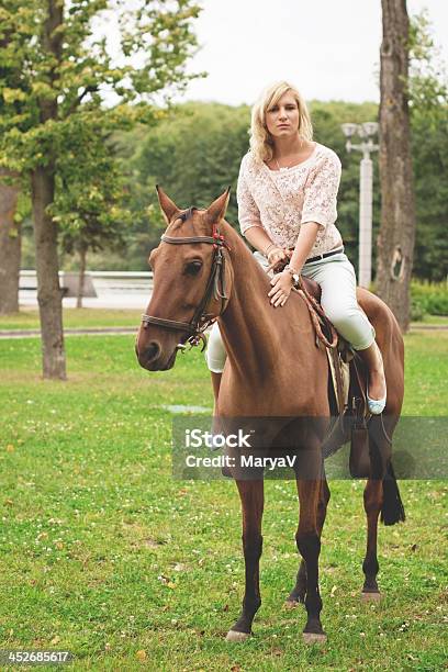 Blonde Riding A Horse Stock Photo - Download Image Now - Active Lifestyle, Activity, Adult
