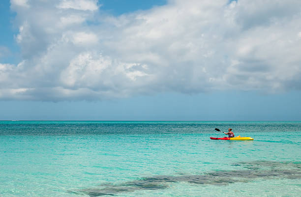 Kayaking on Grace Bay in Turks & Caicos Woman Kayaking on Grace Bay in Turks & Caicos Grace Bay stock pictures, royalty-free photos & images