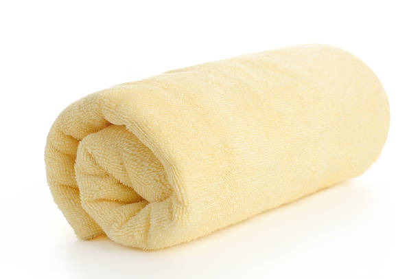 istock rolled up yellow beach towel 452690147
