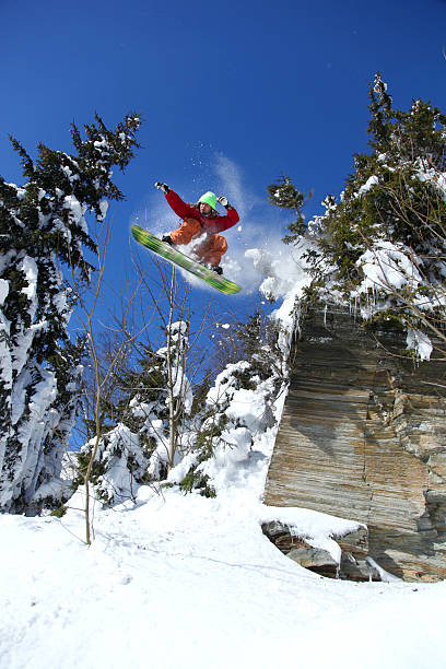 istock Snowboarder jumping against blue sky 452690433
