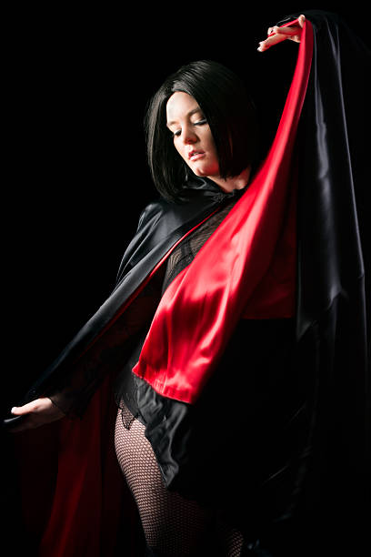 istock Young black haired woman with moving cloak. 452696051