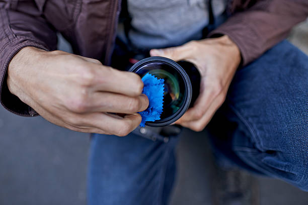 Cleaning the dust off his lens