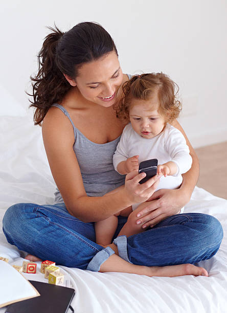 istock Looking at pictures on her mobile phone 452698995