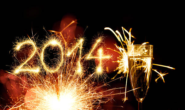 istock Champagne Glass Infront Of Fireworks – New Year 2014 452699559