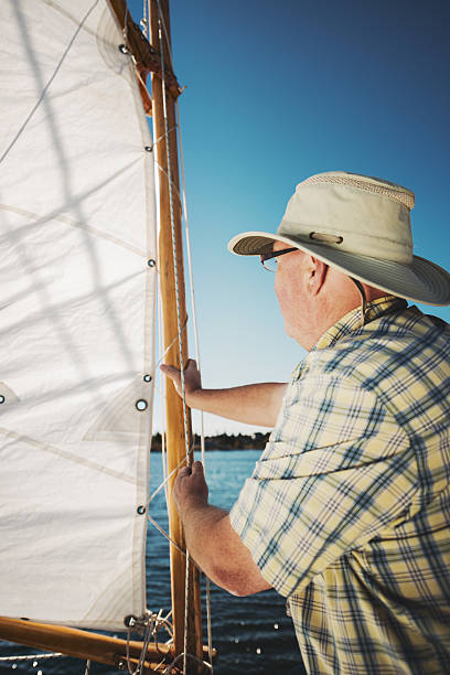 istock Man in his wooden sailboat 452699739