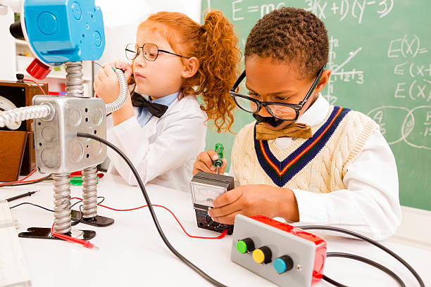 istock Education:  Retro revival children making robot in science lab. 452700183