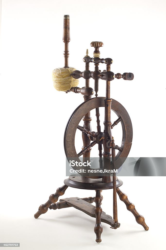 Spinning Wheel Isolated image of an antique spinning wheel. Spinning Wheel Stock Photo