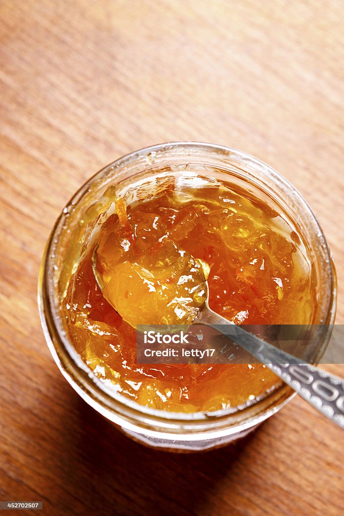 orange jam orange jam in glass jar above on wood table Marmalade Stock Photo