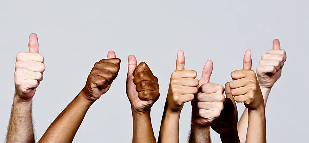 istock Many mixed hands give approving thumbs-up signal 452703263