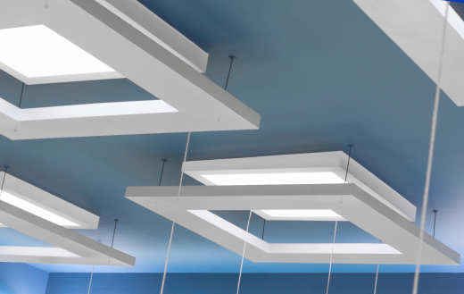 white suspended ceiling  with lights on a blue coloored ceiling