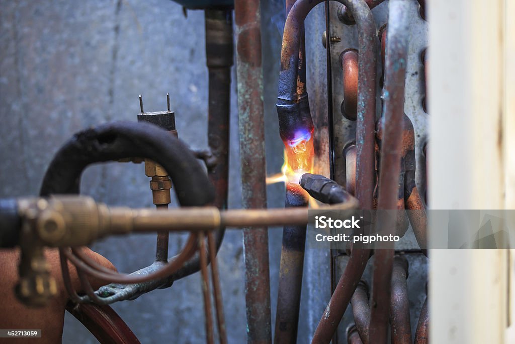 Tuberías de cobre de soldadura reparador y aire acondicionado - Foto de stock de Acero libre de derechos
