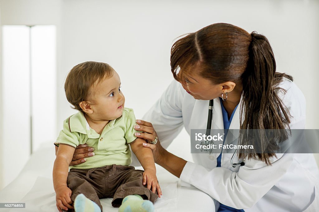 Pediatrition with baby boy A pediatritian with a baby boy 25-29 Years Stock Photo