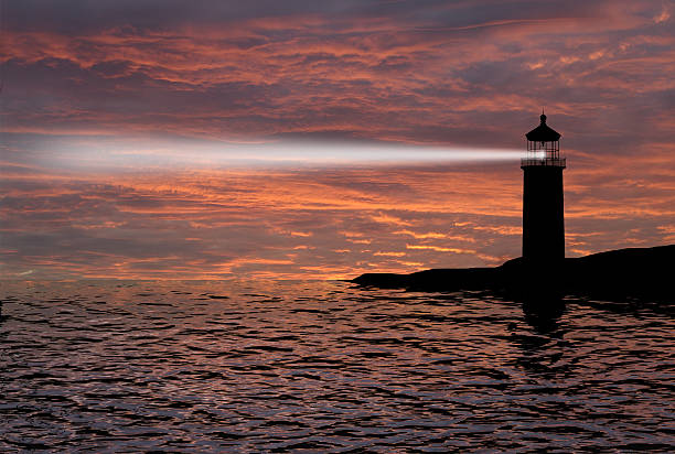 istock Lighthouse searchlight beam through marine air at night. 452723605