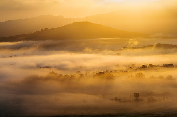 istock Foggy and sunny morning in Tuscany 452724445