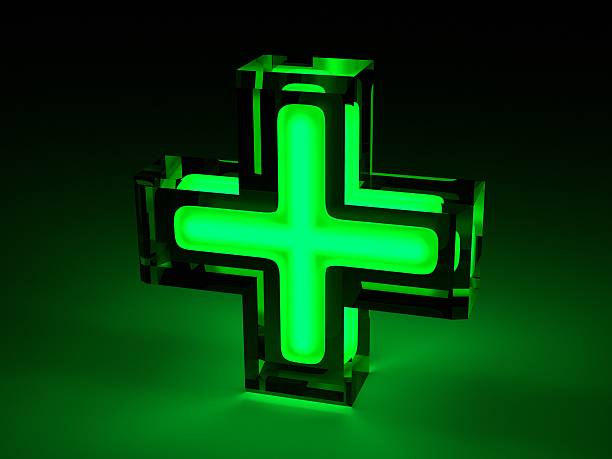 istock Green lit medical cross sign with black borders 452724537