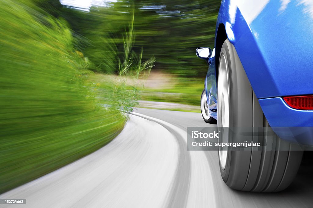 Driving Low angle shot from the back of a car driving fast in a curve Car Stock Photo