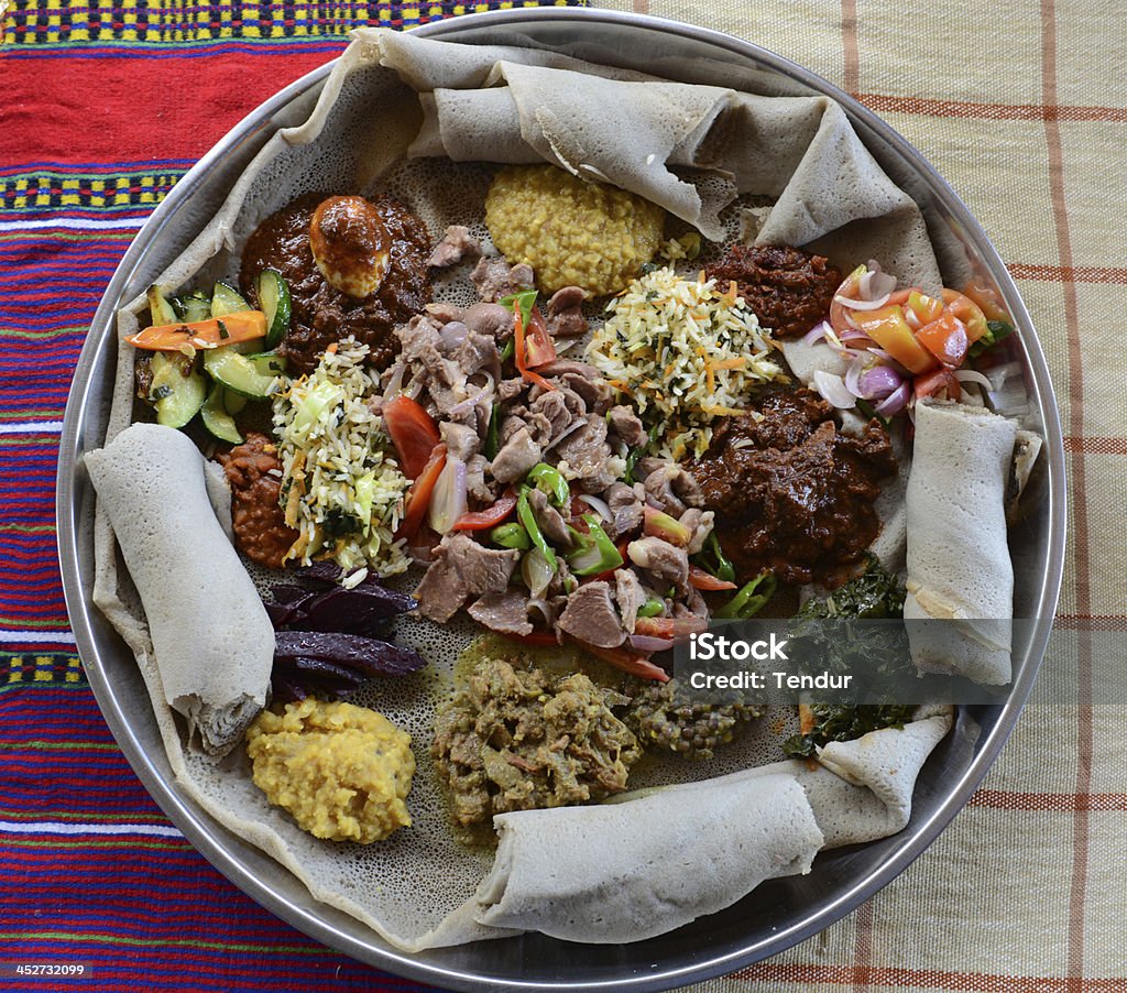 Traditional Ethiopian dish Traditional Ethiopian dish consisting of a meat, vegetables, grains, rice and served with pancake-like injera. Ethiopia Stock Photo