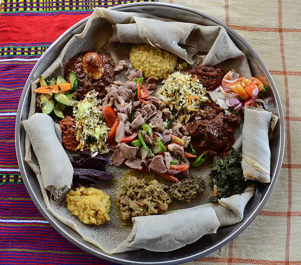 Traditional Ethiopian dish consisting of a meat, vegetables, grains, rice and served with pancake-like injera.