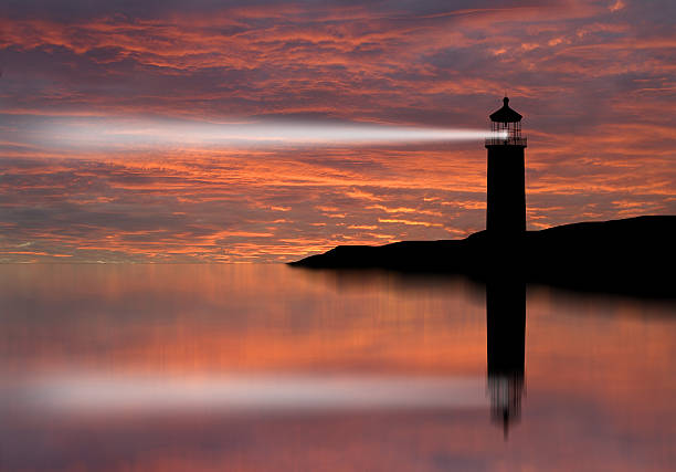 istock Lighthouse searchlight beam through marine air at night. 452739523