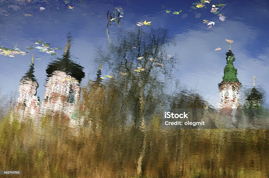 Ukrainian autumn reflection on the water surface Water surface of the autumn lake is reflecting the blue sky, Orthodox churches and bare trees. Architectural Dome Stock Photo