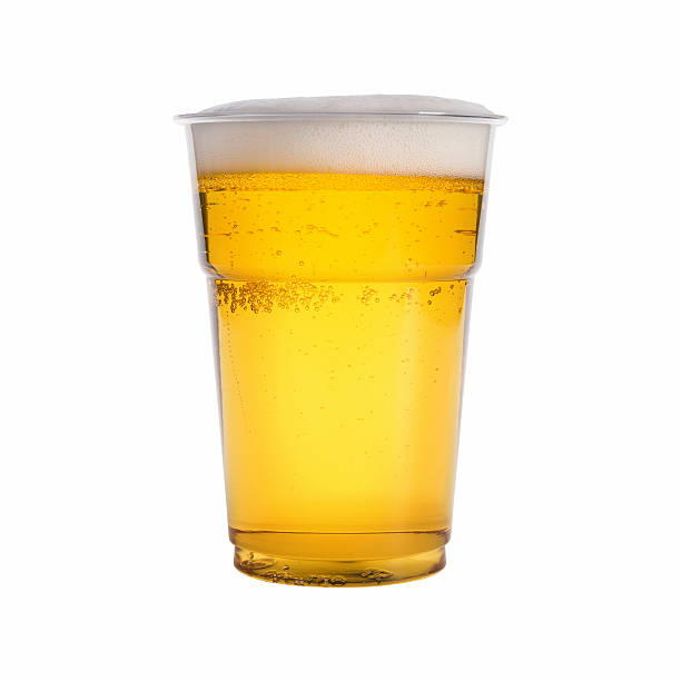 close-up of a glass of beer on a white background - wegwerpbeker stockfoto's en -beelden