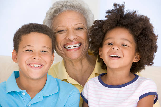 istock Woman and two young children smiling 452748433