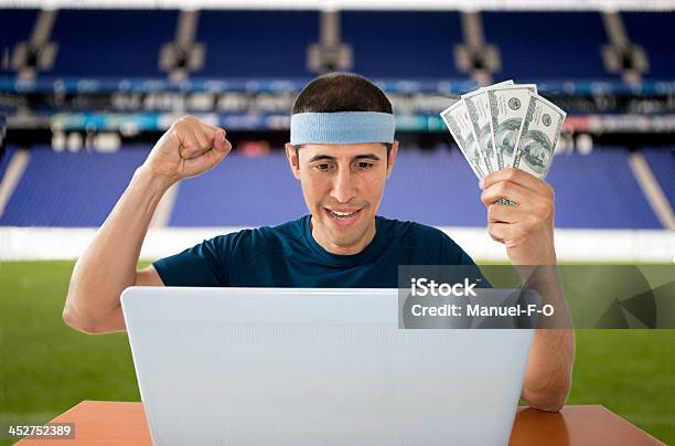 Betting Online Gaining Dollar In Stadium Stock Photo - Download Image Now - Adult, Adults Only, Barricade Tape