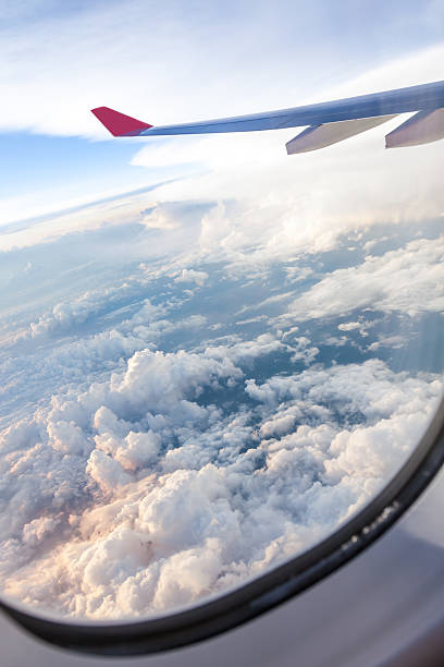istock Clouds and sky as seen through window of an aircraft 452752497