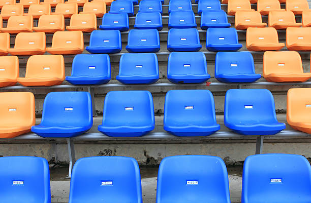 istock plastic, yellow and blue, new chairs in stadium. 452753197