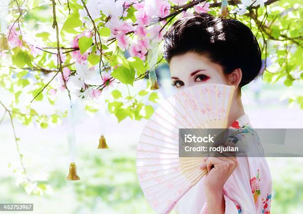 Geisha With Fan In The Garden Stock Photo - Download Image Now - Adult, Adults Only, Asian Culture