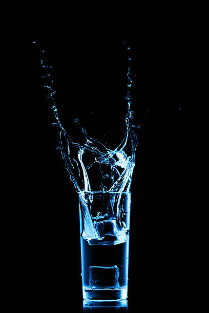 Splashing water in the glass stock photo
