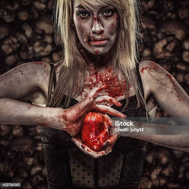 Young Zombie Woman Holding A Human Heart Stock Photo - Download Image Now - Horror, Spooky, Blood