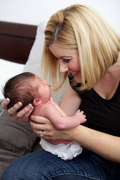 istock Smiling Mother Looking at Her Newborn Baby 452758171