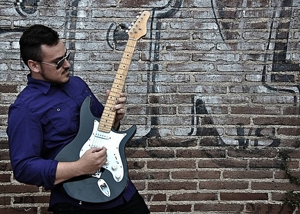 istock musician posing with his guitar 452763053