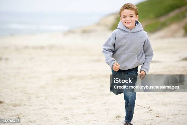 Young Boy Running On Beach Smiling Stock Photo - Download Image Now - Boys, Child, Approaching