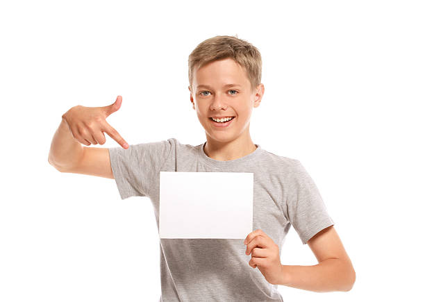 istock Smiling boy pointing at white blank paper 452767461