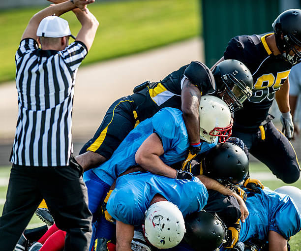 istock Football pile up with coach 452772013