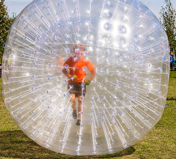 child has fun in the Zorbing Ball child has a lot of fun in the Zorbing Ball zorb ball stock pictures, royalty-free photos & images