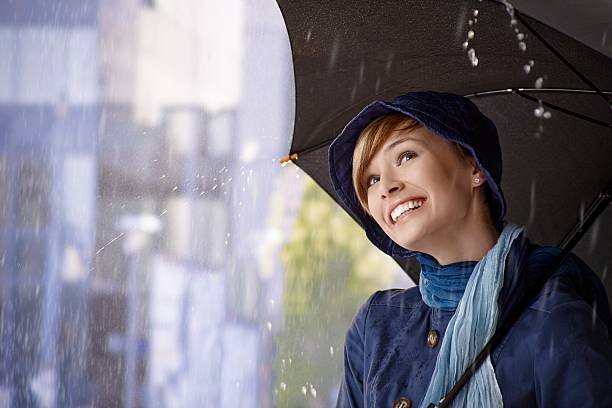 istock Beautiful young woman holding umbrella 452792945