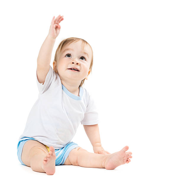 istock baby sitting and points his hand up 452793653