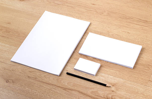 istock Three blank white notepads with black pencil on wooden table 452798855