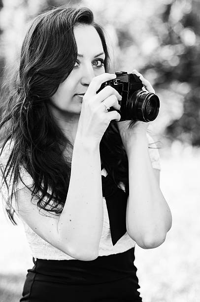 istock Brunette girl and retro camera 452806575