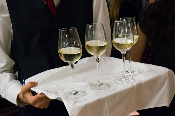 istock A waiter carrying a tray of white wine 452808915