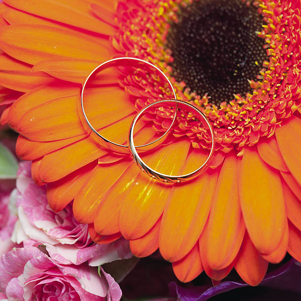istock wedding rings  groom and bride on a bunch of flow 452958939