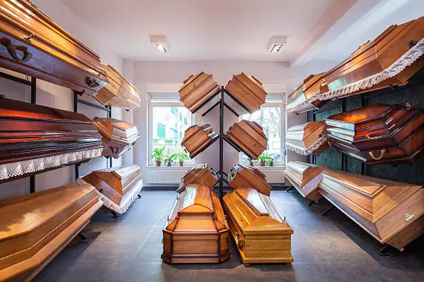 Photo of A funeral home with coffins being sold