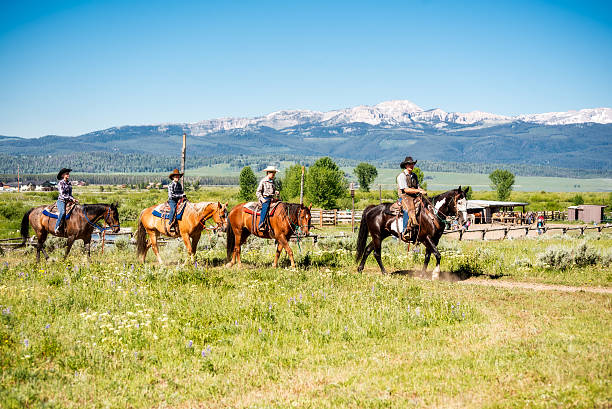 Family Vacationing on Horse Back at Dude Ranch in Montana Young Family of four vacationing on horse back at Dude Ranch ranch stock pictures, royalty-free photos & images