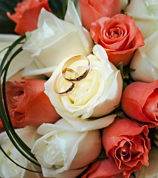 istock wedding rings  groom and bride on a bunch of flow 452967755