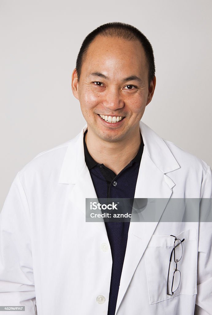Asian Man Asian man in a white lab coat. 30-39 Years Stock Photo