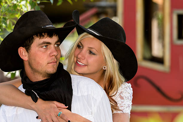 istock Wedding:  Cowboy, cowgirl.  Bride hugs groom affectionately. 452969193